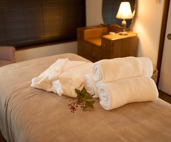 Gowns and towels on the bed in the beauty salon